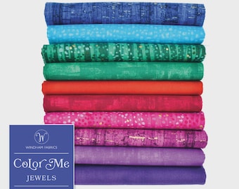 May include: A stack of ten folded fabric fat quarters in a gradient of blue, teal, green, red, pink, and purple hues. A blue rectangular label features the text Windham Fabrics, Color Me Jewels, and bundle contents 10 fat quarters.