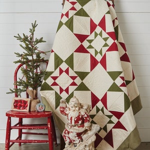 May include: A quilt pattern featuring a red and green star design. The quilt is 72 inches by 72 inches and is called "Spiced Gumdrops Quilt".