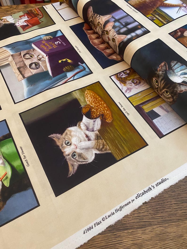 May include: A beige fabric with a repeating pattern of cats in various poses. Each cat is framed in a black border and has a caption below. The captions include "Guest for Dinner", "Spill the Beans", "Cat Burglar", "Crooks", "Guide to Theft", and "Fast Steps". The fabric is labeled "41004 Flax Lucia Heffernan for elizabeth's studio."