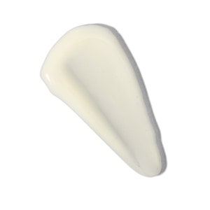 May include: A close-up of a white, creamy, smooth texture of a beauty product. The texture is thick and appears to be a lotion or cream.