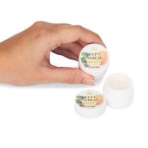 May include: Two small white jars with a lemon and green leaf design on the label. The label reads "Deep C Serum Sample Size" and "Lhskin.com".