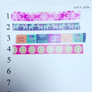 May include: A set of eight washi tapes with various designs. The tapes feature pink, blue, green, and orange colors. The designs include mandalas, elephants, and inspirational quotes. The quotes include "enjoy today", "have courage", "be strong", "embrace the journey", and "enjoy the ride".