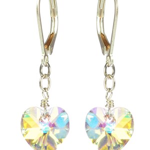 May include: A pair of silver dangle earrings with iridescent heart-shaped crystals.