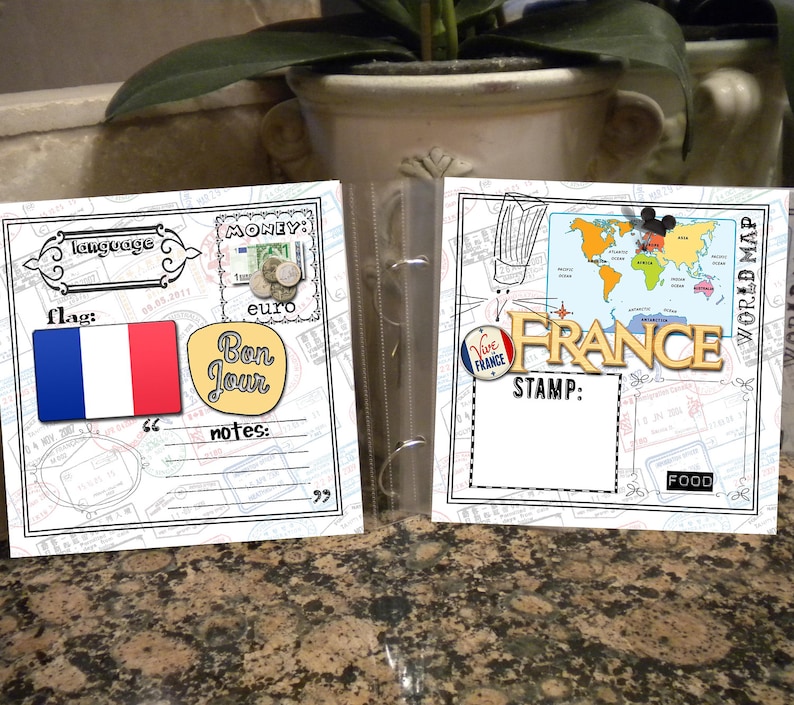 May include: A scrapbook page with a white background and black borders. The page is decorated with images of a French flag, a world map, and a stamp that says "Vive France". The page also includes text that says "language", "flag", "money", "euro", "Bon Jour", "notes", "STAMP", "FOOD", and "WORLD MAP".