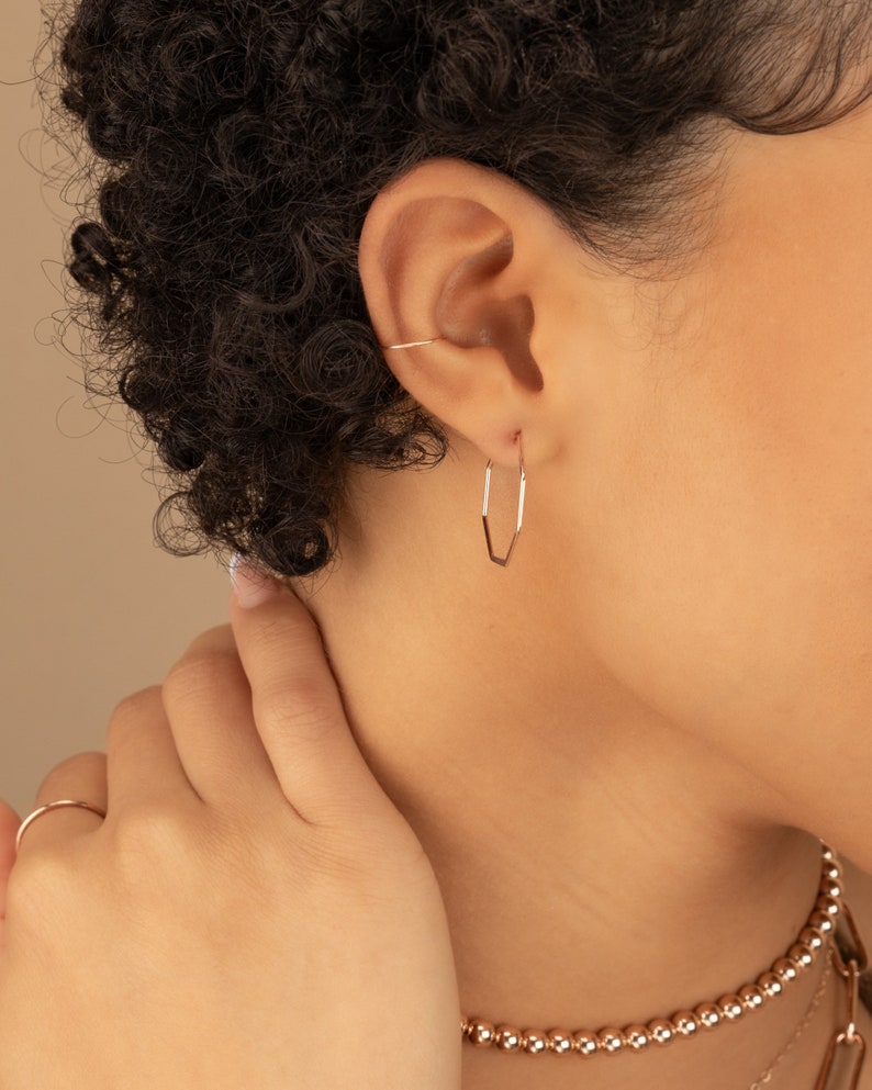 a close up of a person wearing a necklace