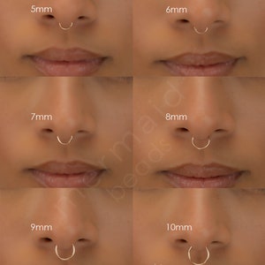 May include: Six images showing different sizes of gold septum rings. The sizes are 5mm, 6mm, 7mm, 8mm, 9mm, and 10mm. The images show the rings worn in a septum piercing.