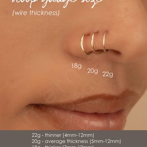 a close-up of a person's nose with three hoop earrings attached, providing size information for the hoop gauge sizes.
