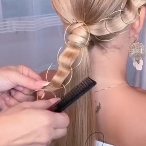 a woman getting her hair done by a hair stylist