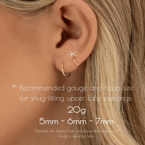 May include: A close-up of an ear with two gold hoop earrings and a small star-shaped stud earring. The image includes text recommending a 20g gauge and 5mm-7mm hoop size for snug-fitting upper lobe piercings.
