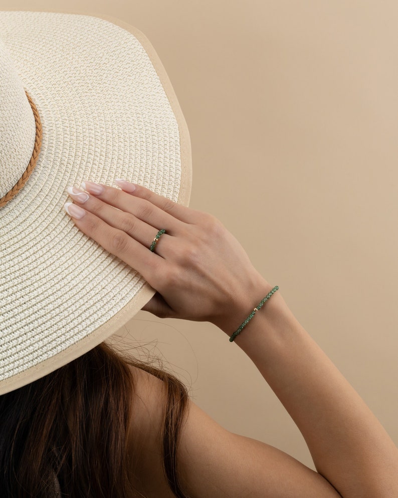 a woman wearing a white hat covering her face