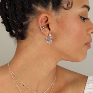 a woman wearing a necklace and earring set