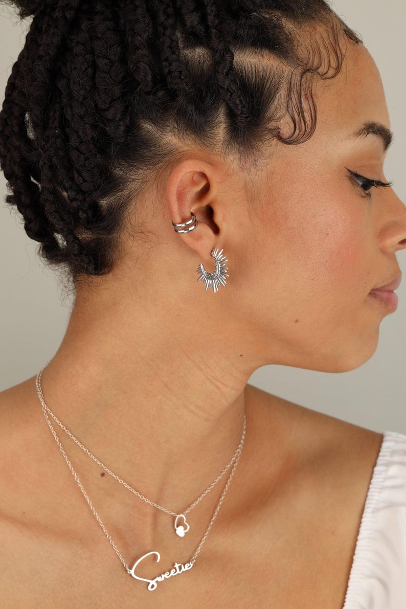 a woman wearing a necklace and earring set