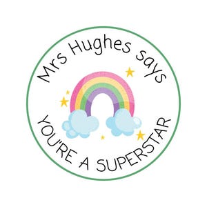 May include: A round sticker with a green border and the text "Mrs Hughes says YOU'RE A SUPERSTAR". The sticker features a rainbow, clouds, and stars in a colorful design.