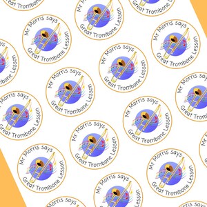 May include: A sheet of stickers with a repeating pattern of a gold trombone on a blue background. The stickers say "Mr. Morris says Great Trombone Lesson".
