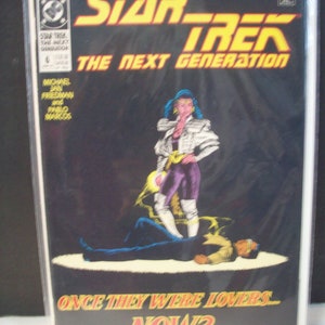 May include: A comic book cover featuring a woman in a white jacket and purple pants standing over a man lying on the ground. The cover is black with yellow text that reads "Star Trek: The Next Generation" and "Once They Were Lovers... Now?"