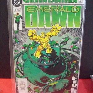 May include: Green Lantern comic book cover featuring a green lantern and a large, golden, humanoid figure. The title of the comic is "Green Lantern Emerald Dawn" and the issue number is 5. The text "Five of Six" is in the lower right corner.