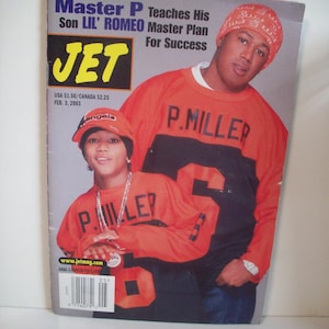 May include: A magazine cover featuring Master P and his son Lil' Romeo. The cover has the title "JET" in yellow letters. Both are wearing orange and black sweatshirts with "P. MILLER" and the number "5" on them. The magazine's publication date is February 3, 2003.