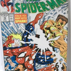 May include: A comic book cover featuring Spider-Man in a blue and red suit, fighting a villain in a yellow and brown suit. The cover is titled "Web of Spider-Man" and features the text "Face-to-Fist with Spark!" and "Art Attack! Part 3 of 41".