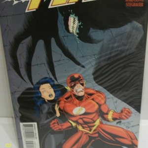 May include: The Flash comic book cover featuring The Flash in his red and yellow suit, a woman with black hair, and a shadowy figure with sharp teeth. The title of the comic is "The Flash" and the subtitle is "Dark Secrets". The issue number is 103.