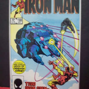 May include: A comic book cover featuring Iron Man in a red and gold suit, flying through the air and firing repulsor rays. The cover also features a large, blue and gray spaceship with a yellow explosion behind it. The text on the cover reads "Iron Man" and "Two Iron Men - Last Time!"