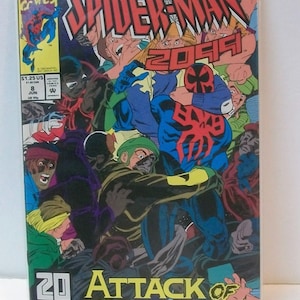 May include: A comic book cover featuring Spider-Man 2099 in a blue and red suit with a spider symbol on his chest. He is surrounded by a group of people in various poses, some of whom appear to be attacking him. The cover text reads "Spider-Man 2099" and "Attack of the Freakers".