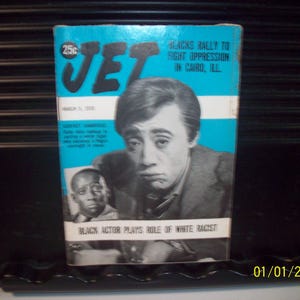 May include: A vintage issue of Jet magazine. The cover features a black and white image of an actor with the headline "Black Actor Plays Role of White Racist." The magazine has a blue background with white stripes and the text "Blacks Rally to Fight Oppression in Cairo, Ill."