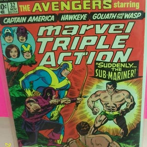 May include: Marvel Comics Group's "The Avengers" comic book. The cover features Captain America, Hawkeye, Goliath, and The Wasp. The comic book has a red background with action scenes of superheroes.