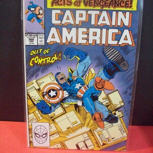 May include: Captain America comic book cover featuring a red, white, and blue superhero fighting a large, blue, and purple villain. The cover text reads "Acts of Vengeance! Captain America" and "Out of Control!"