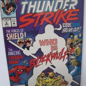 May include: A comic book cover for Thunderstrike, featuring a purple background with red and white text. The cover includes illustrations of Spider-Man, Blackwulf, and other characters. The text reads "Who is Blackwulf?" and "The Amazing Spider-Man!"