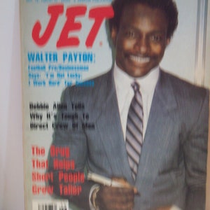 May include: A magazine cover featuring Walter Payton, a football player, in a grey suit and tie. The magazine is called "JET" and the cover text reads "Walter Payton: Football Pro/businessman says: "I'm not lucky, I work hard for success."