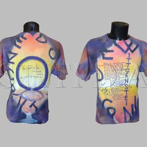 May include: A tie-dye t-shirt with a colorful abstract design and text that reads "The limit is to be reached, not to be surpassed." The shirt is a blend of purple, orange, yellow, and white.