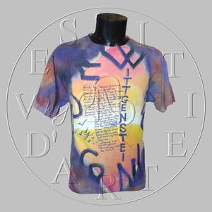 May include: A tie-dye t-shirt with a colorful design and text that reads "Words Are Saved Sources Of Life & Imagination. The World Is What They Become. They Use It As Music. Notes Mean Something. Notes Made The World. So Music Is The Meaning Without Letters. Without Words. Because Without The Words There Is No Music. As So Just Imagine. It Is Not Enough To Just Communicate. So We Can Argue. And The More We Know The More We Must Think We Know. Because We Are Not Making Noise. Just making one. What we speak cannot speak. There must be silence..."