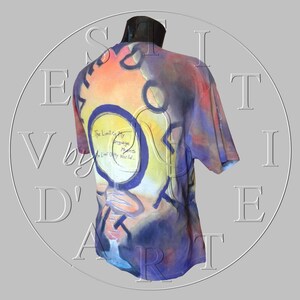 May include: A colorful t-shirt with a purple, blue, orange, and yellow abstract design. The text "The Limit of My Language Means The Limit Of My World..." is printed on the shirt.