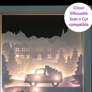 May include: A white silhouette of a Christmas scene with a truck carrying a Christmas tree, houses, and trees. The silhouette is lit from behind, creating a glowing effect. The text "Merry Christmas" is written below the truck. The image is compatible with Cricut and Silhouette Scan N Cut machines.