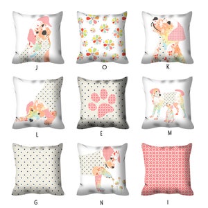 May include: Nine different pillow designs featuring a dog illustration. The pillows are white with various patterns including polka dots, floral, and paw prints. The dog illustrations are in a patchwork style with pink, yellow, and blue colors.