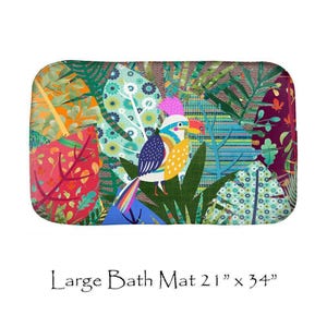 May include: A rectangular bath mat measuring 21 inches by 34 inches featuring a vibrant, multi-colored graphic print of a toucan surrounded by stylized tropical leaves, floral patterns, and geometric shapes in shades of green, red, and blue.