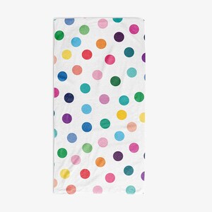 a white towel with a pattern of multicolored polka dots.