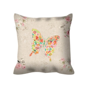 May include: A decorative pillow with a floral pattern and a colorful butterfly design. The butterfly is made up of smaller floral patterns.