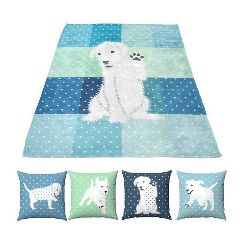 a blue minky blanket with a white dog on it, and there are four matching throw pillows with white dogs on them.