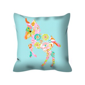 May include: A turquoise blue pillow with a colorful zebra print. The zebra is in a playful pose with its legs up in the air.
