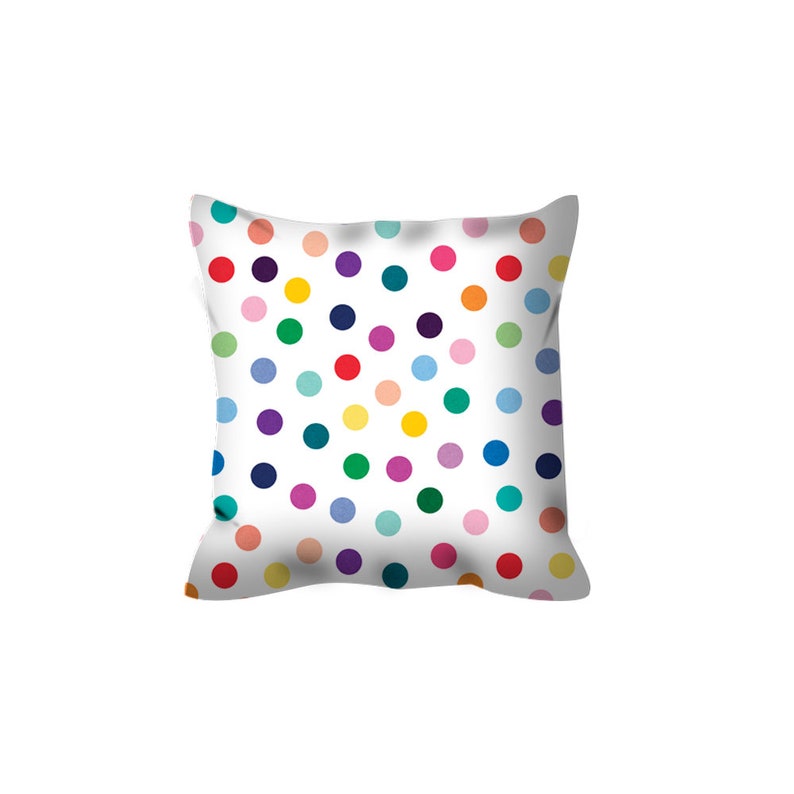 May include: A white throw pillow with a colorful polka dot pattern. The dots are in various shades of red, orange, yellow, green, blue, purple, and pink.