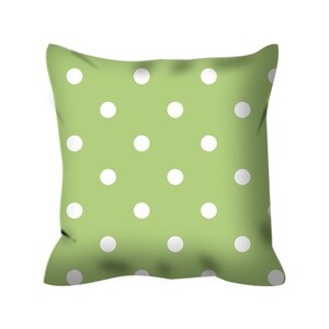 May include: A green pillow with a white polka dot pattern.