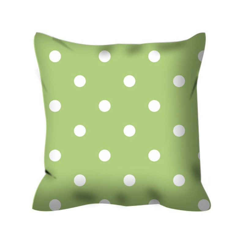 May include: A green pillow with a white polka dot pattern.