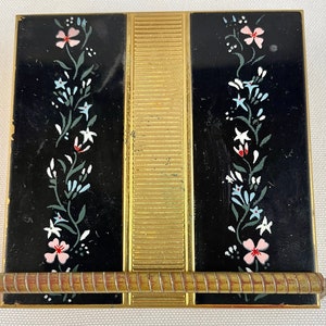 Vintage Volupte Square Goldtone and Black Enamel Compact Decorated with Flowers with a Bar Closure