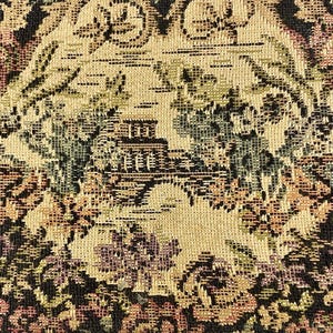 May include: Close-up of a tapestry with a detailed floral and architectural design. The color palette includes beige, green, purple, and black, creating a vintage aesthetic. The woven fabric features a repeating pattern of stylized flowers and buildings.