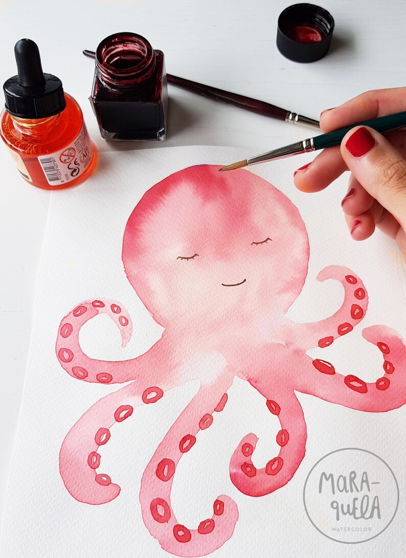 May include: A watercolor painting of a pink octopus with closed eyes and a smile. The octopus has eight tentacles with red circles on them. The painting is signed "Mara-quella Watercolor" in the bottom right corner.