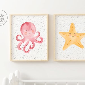 May include: Two framed watercolor illustrations of sea creatures. The first illustration features a pink octopus with a smiling face. The second illustration features a yellow starfish with a smiling face. Both illustrations have a white background with small black dots.