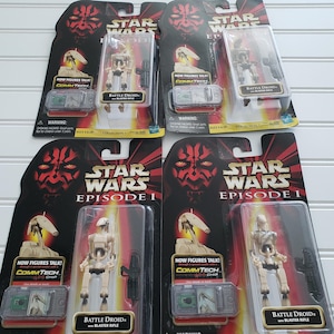 May include: Four Star Wars Episode I Battle Droid action figures in original blister packaging. Each tan droid includes a black blaster rifle and a green CommTech chip. The black backing cards feature Darth Maul graphics and product text.