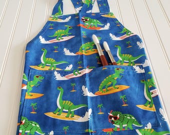 Surfing Dinosaur Child Apron, Blue Kids Cooking Apron with Divided Pocket