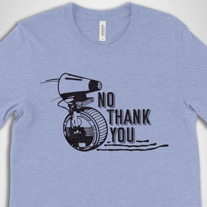 May include: A light blue t-shirt with a black and white graphic of a droid from Star Wars with the text "NO THANK YOU".